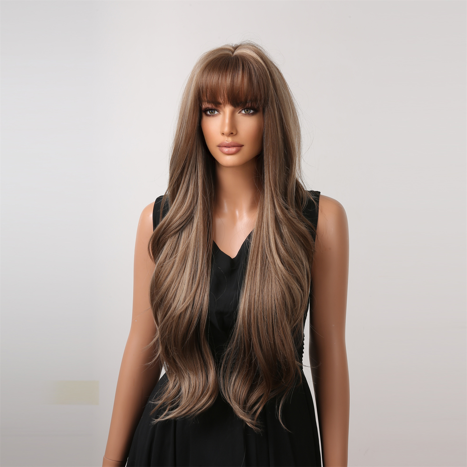 A trendy dark brown wig with long curly hair and bangs, made from synthetic material for easy wear and a stylish appearance