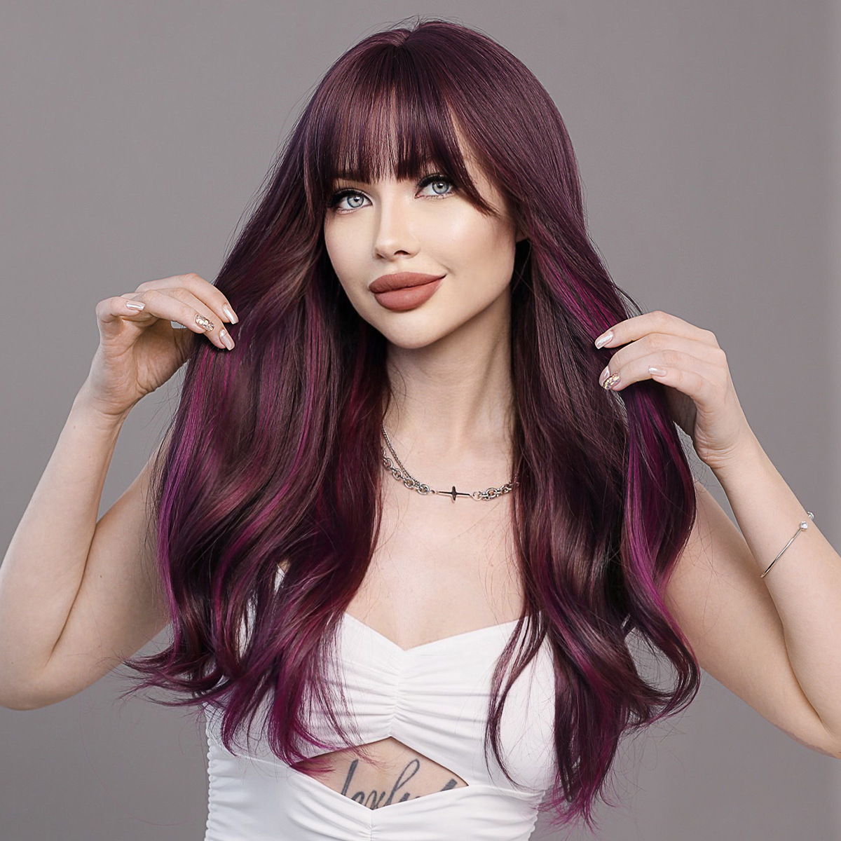 Image of a synthetic wig in purple brown with long wavy hair and bangs, styled and ready to go