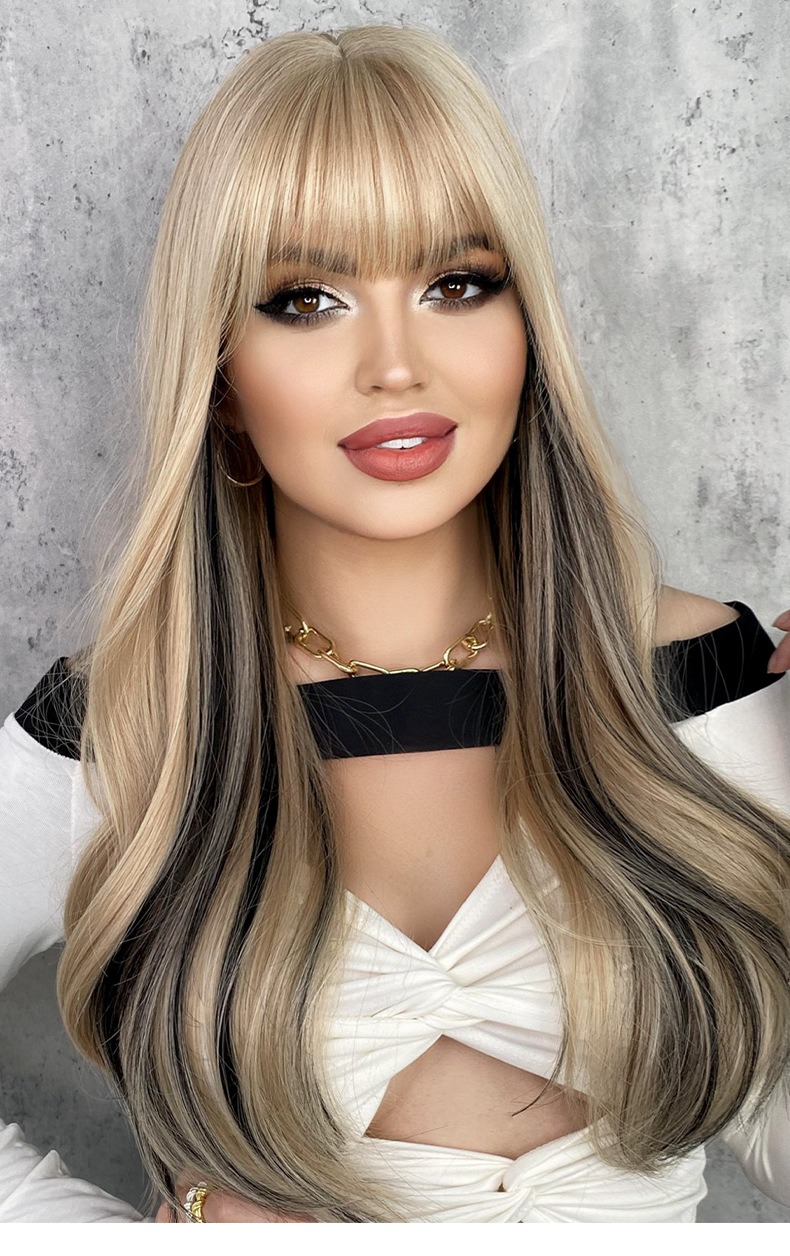 A synthetic wig featuring blonde long curly hair with bangs and highlights dyed into large waves