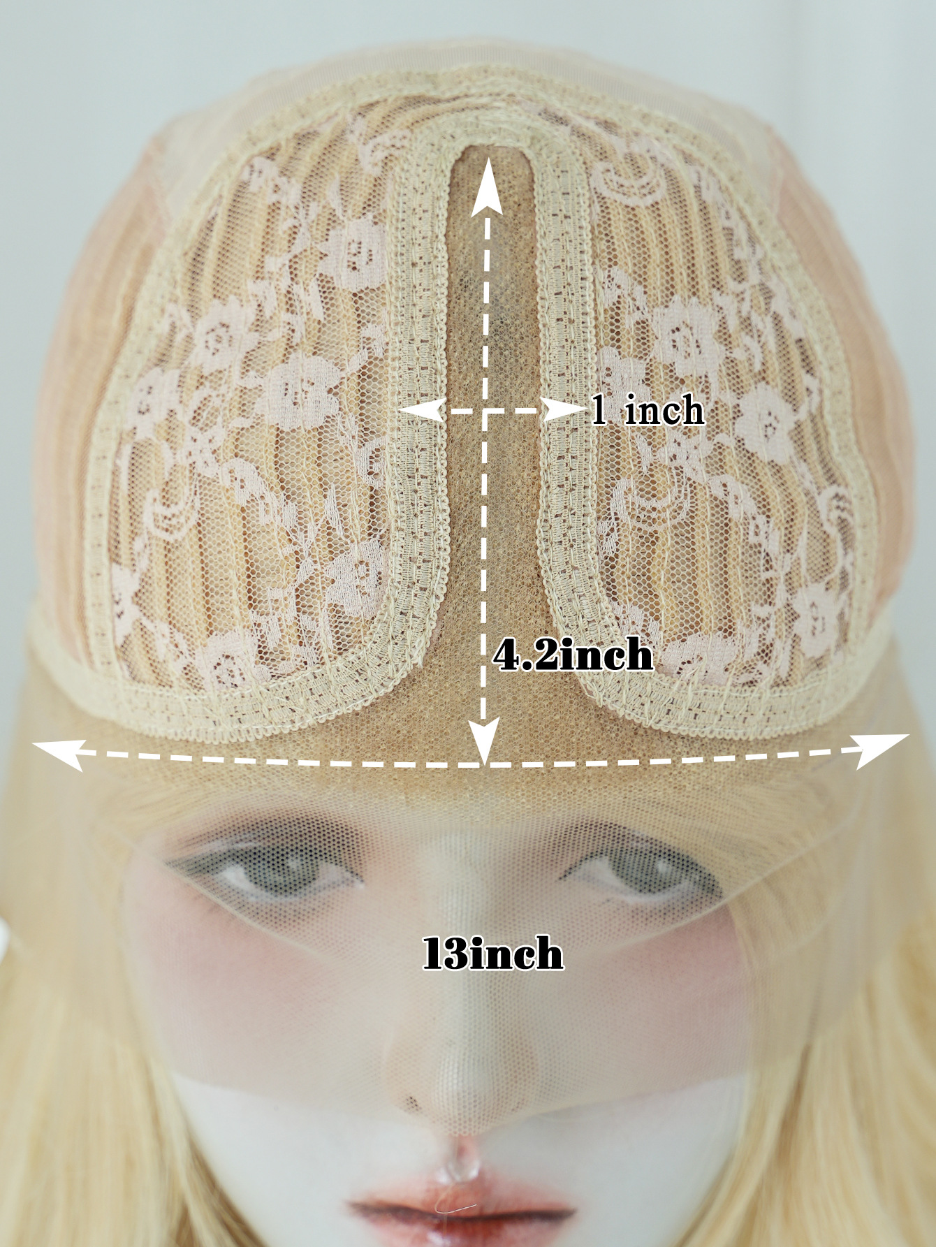 A women's synthetic wig with handwoven construction, featuring a medium parted style and light blonde color