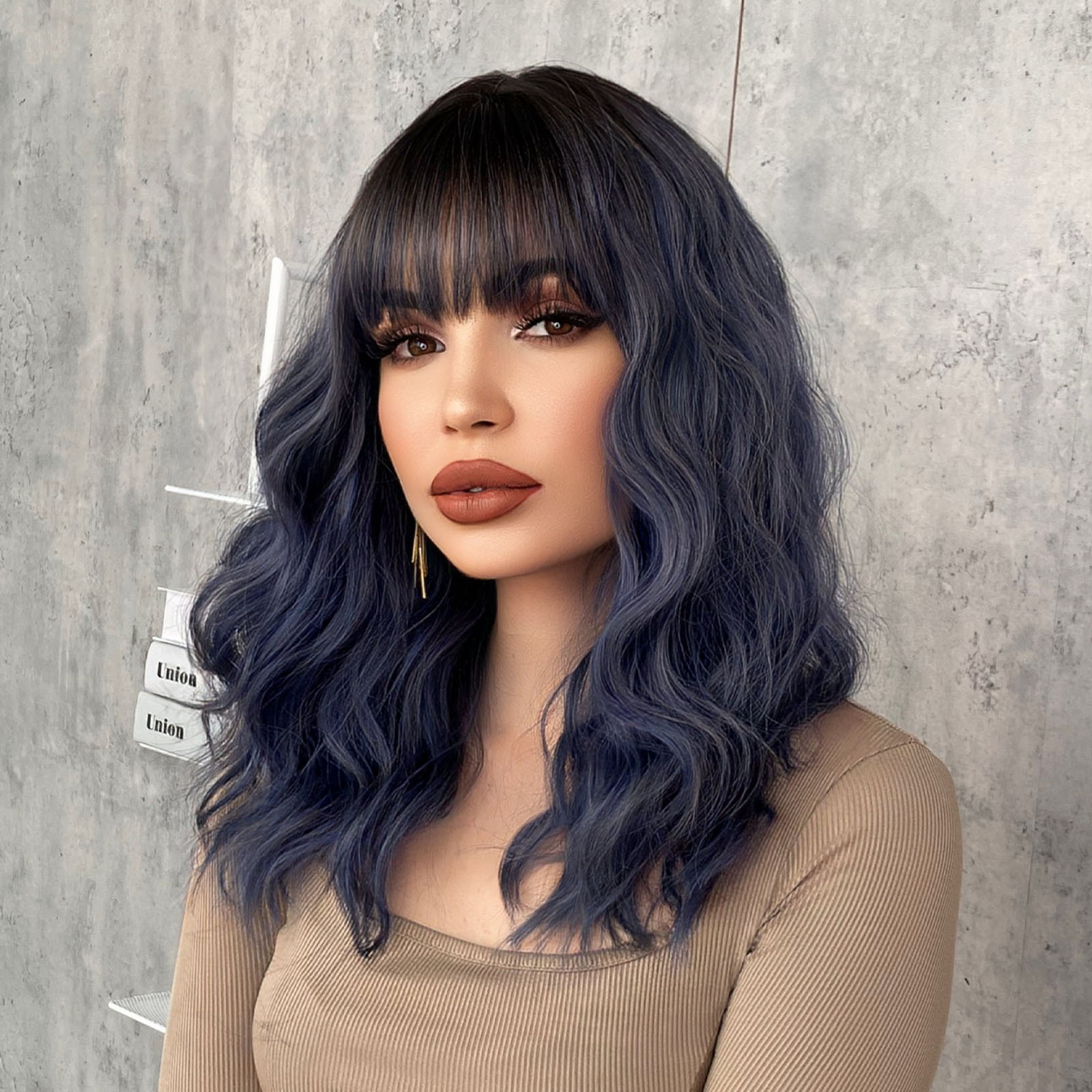 A stylish synthetic wig in female haze blue, featuring wavy medium-length curly hair, perfect for a ready-to-go look