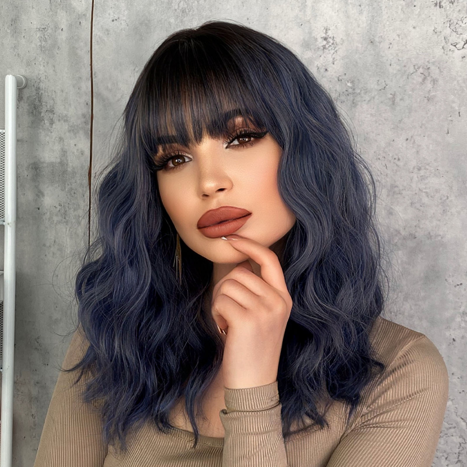 A trendy female haze blue wig with wavy medium-length curly hair, made from synthetic material for an effortless and stylish appearance