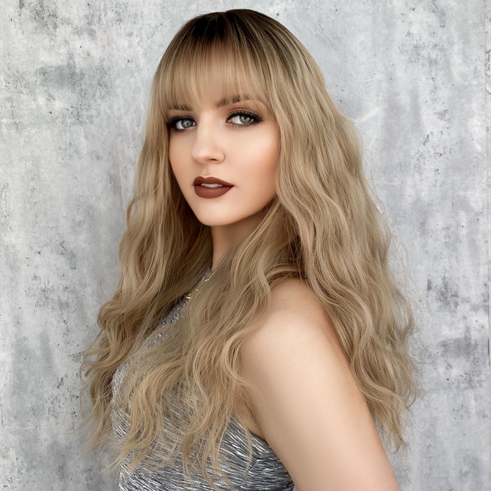 Image of a synthetic wig designed for women, featuring long wavy blonde hair set on a rose net for easy wear