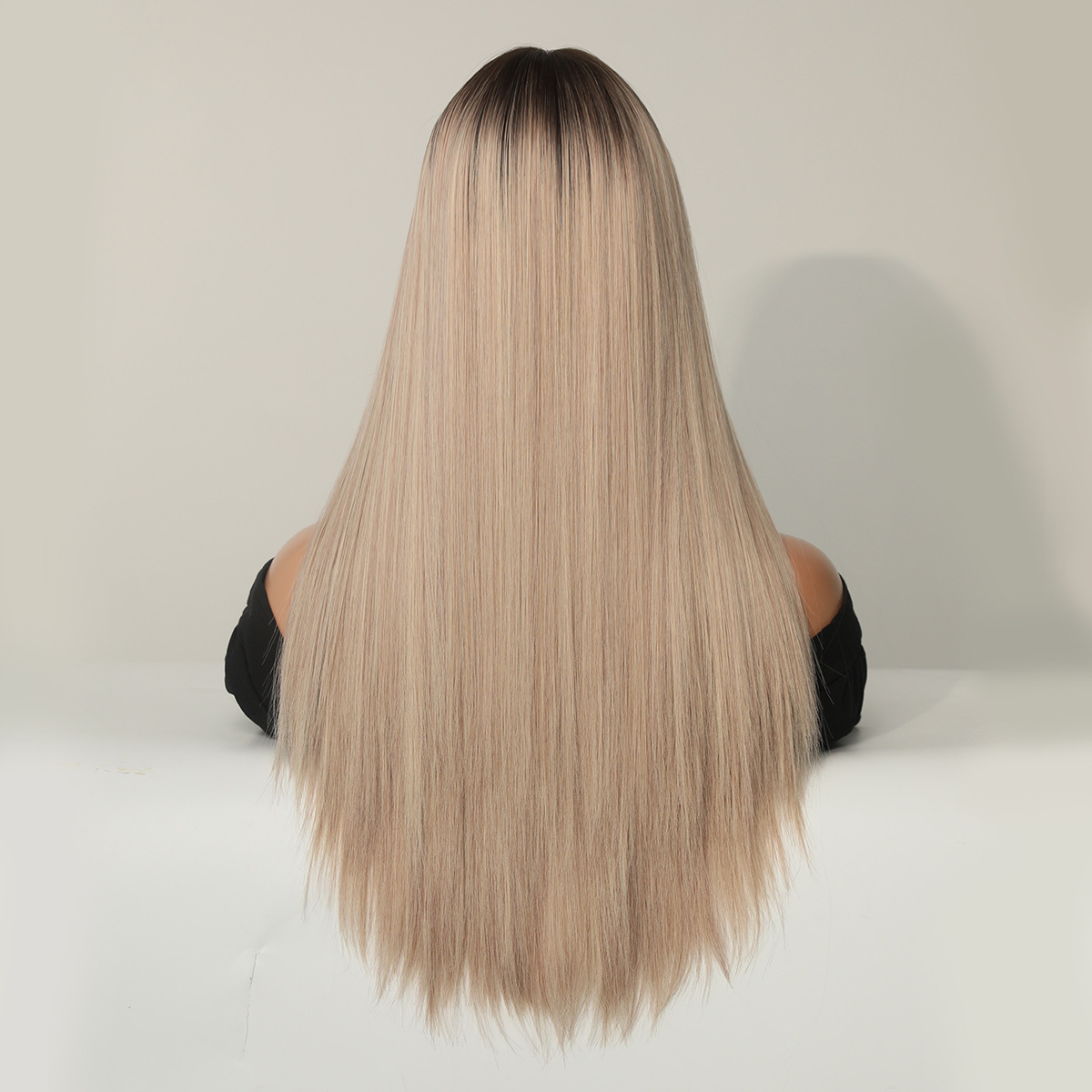 A stylish synthetic wig in champagne blonde with long straight hair, ready to go for any occasion