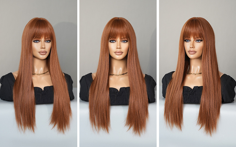 A synthetic wig in wine red with long straight hair and bangs, prepared and ready for use.