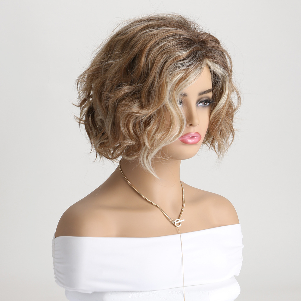 A synthetic wig featuring diagonal bangs and a mix of light blonde and brown tones, styled in a fluffy short curly desig