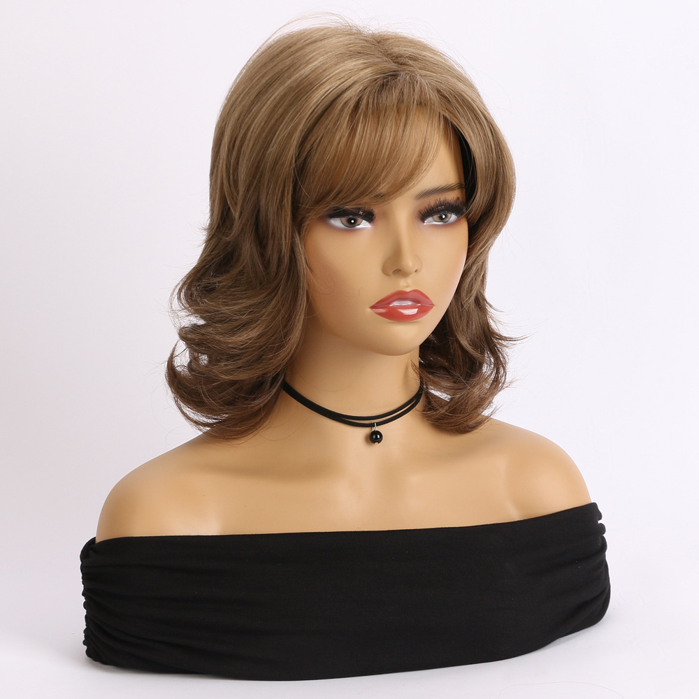 A synthetic wig in light brown with short curly loose hair, comes with headgear for convenience