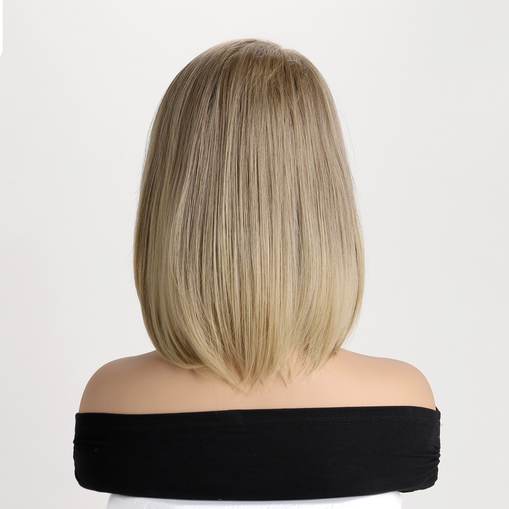 A fashionable wig in light blonde, styled as a short straight synthetic wig with bangs for women
